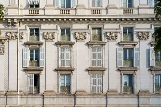 nice windows. beautiful windows with shutters. Beautiful wooden window shutter with windowsill, cement wall and sunny day