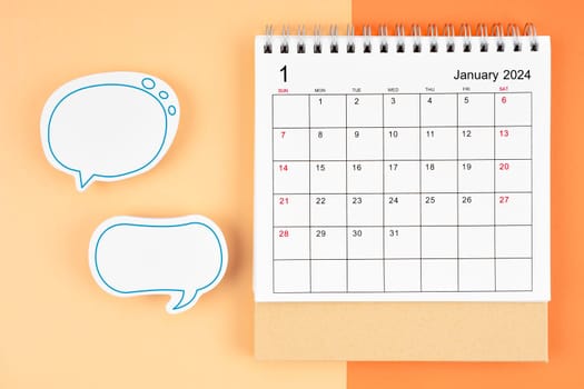 January 2024 desk calendar and empty speech bubble on beautiful background.