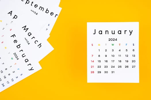 Calendar page for January 2024 on a yellow background.
