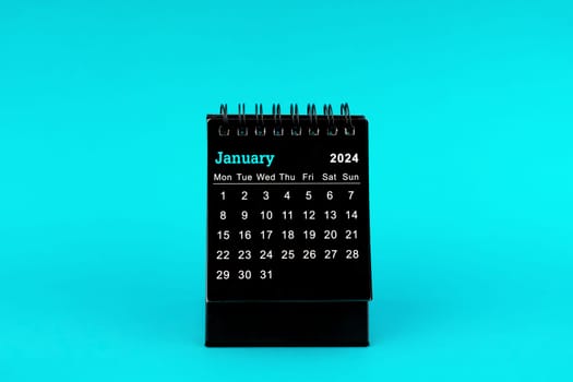 Black Calendar for January 2024. Desktop calendar on a green color background.