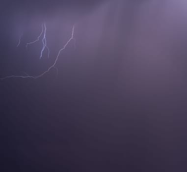 Dramatic lightning illuminates a purple night sky, showing nature's might.