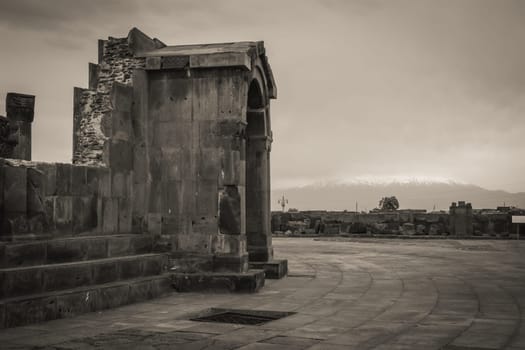 Side view of ancient doorway in Zvartnos temple in Armenia photo. Beautiful old church entrance photography. High quality picture for magazine, article