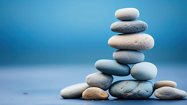 A stack of ugly smooth stones on a blue background.