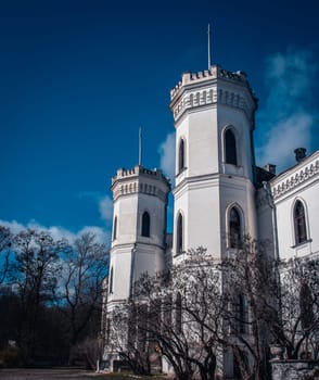 The tower of the old palace in neo-gothic style. Sugar Palace in Kharkov region, Ukraine. Towers of medieval castle. A beautiful historical building in a European city.
