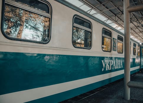 Close up train on the station concept photo. Passenger vehicle. Railway platform. Railroad in Europe. Commercial transportation. High quality picture for wallpaper, travel blog.