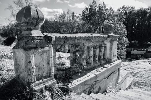 Ancient parapet and staircase concept photo. Castle ruins terrace view. Ruined ancient palace in Ukraine. Black and white close up photo. A beautiful historical building in a European city.