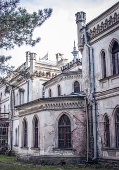 The old palace yard concept phot. Back view of the castle tower. Neo-gothic building in European town. High quality picture for wallpaper. Sightseeing of Ukraine
