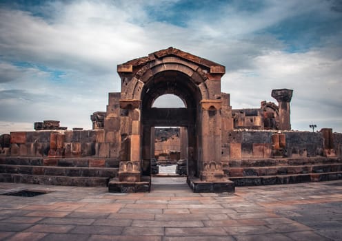 View of ancient doorway in Zvartnos temple in Armenia concept photo. Beautiful old church arch entrance photography. High quality picture for magazine, article