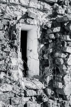 Castle ruins window view concept photo. Ruined ancient palace in Ukraine. Black and white close up photo. A beautiful historical building in a European city.