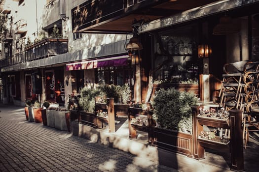 Street view with beautiful buildings and cafe terrace during the morning light concept photo. One of the streets of Yerevan. Magic country Armenia. District scene. High quality picture for magazine, article
