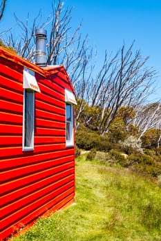 The historic Valentine Hut in Kosciuszko National Park near Schlink Pass on a clear summer's day, in the Snowy Mountains, New South Wales, Australia