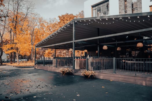 Street view with cafe terrace in the autumn concept photo. One of the streets of Europe, Ukraine. District scene. High quality picture for magazine, article