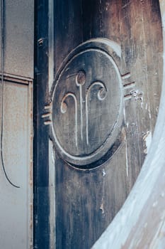 Close up decorative element of a wooden door concept photo. Urban architectural photography. High quality picture of historical building element