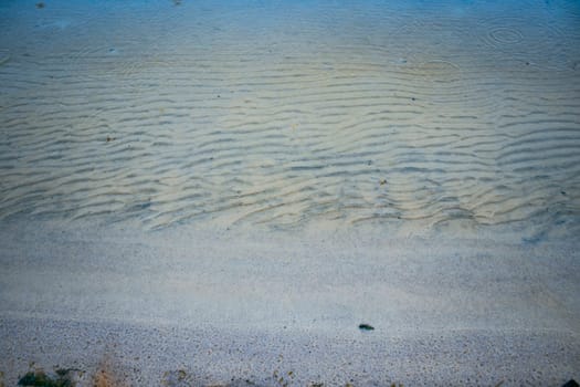 Close up white sand beach and waves concept photo. Country side resort. Front view photography with blurred background. High quality picture for wallpaper, travel blog, magazine, article