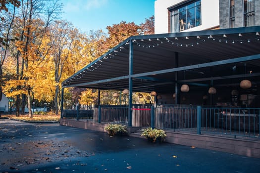 Street view with cafe terrace in the autumn concept photo. One of the streets of Europe, Ukraine. District scene. High quality picture for magazine, article