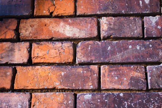 Close up red brick texture wall concept photo. Brick walls old architecture, urban city life. District of European town. High quality picture for wallpaper, travel blog.