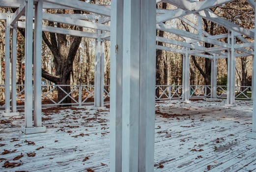 View of the wooden gazebo house in park concept photo. Urban city life. Parkland of European town. High quality altanka picture for wallpaper