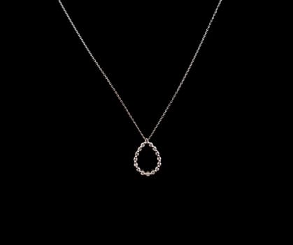 Luxury expensive diamond necklace jewelry on white gold chain displayed against black background