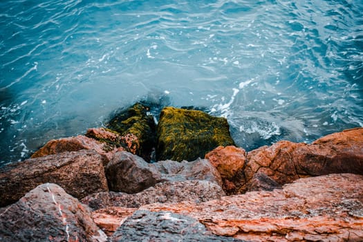 Close up water with stones on the beach concept photo. Underwater rock. Mediterranean winter sea. The view from the top, nautical background. High quality picture for wallpaper