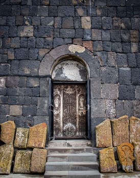 Gothic arched doorway and ancient stone cross concept photo. Monastery entrance, old stone architecture. High quality picture for wallpaper