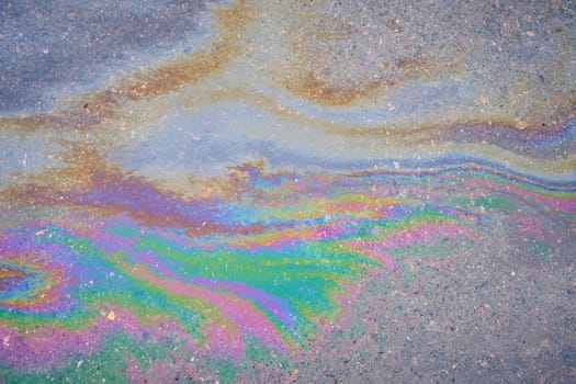 Fuel or oil stains on an asphalt road as a texture or background.