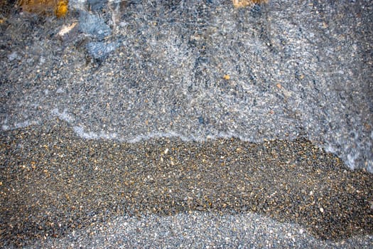 Close up water with stones background concept photo. Pebbles under water. The view from the top, nautical background. High quality picture for wallpaper