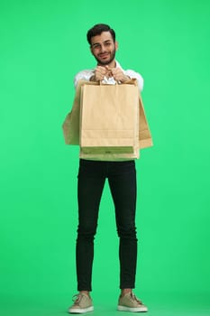 Man on a green background with shoppers.