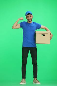 A man on a green background with box.