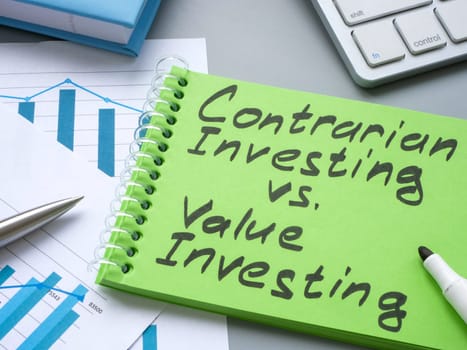 Notebook with sign contrarian investing vs value investing.