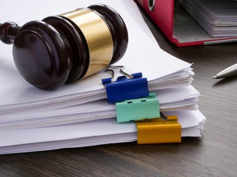 A stack of accounting papers and a gavel. Financial white-collar crime and embezzlement.