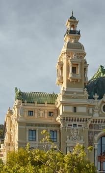 Monaco, Monte-Carlo, 21 October 2022: Tower of Casino Monte-Carlo at sunset, wealth life, famous landmark, pine trees, blue sky. High quality photo