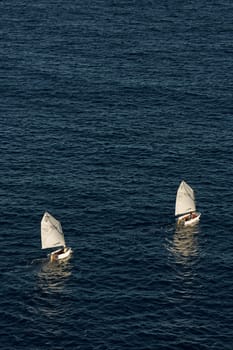 Monaco, Monte Carlo, 05 November 2022 - Two small sailing boats in sea at sunset, mediterranean lifestyle. High quality photo