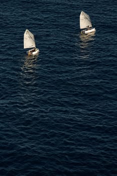 Monaco, Monte Carlo, 05 November 2022 - Two small sailing boats in sea at sunset, mediterranean lifestyle. High quality photo