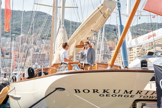 Monaco, Monte Carlo, 29 September 2022 - Invited wealthy clients inspect mega yachts at the largest fair exhibition in the world yacht show MYS, port Hercules, yacht brokers, sunny weather. High quality photo