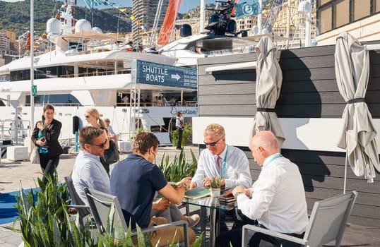 Monaco, Monte Carlo, 28 September 2022 - a lot of people, clients and yacht brokers look at the mega yachts presented, discuss the novelties of the boating industry at the famous motorboat exhibition. High quality photo