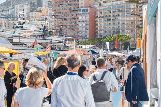 Monaco, Monte Carlo, 28 September 2022 - a lot of people, clients and yacht brokers look at the mega yachts presented, discuss the novelties of the boating industry at the famous motorboat exhibition. High quality photo