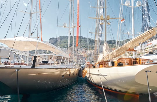 Monaco, Monte Carlo, 28 September 2022 - view on the famous yacht show through sailing yacht, exhibition of luxury mega yachts, yacht brokers. High quality photo