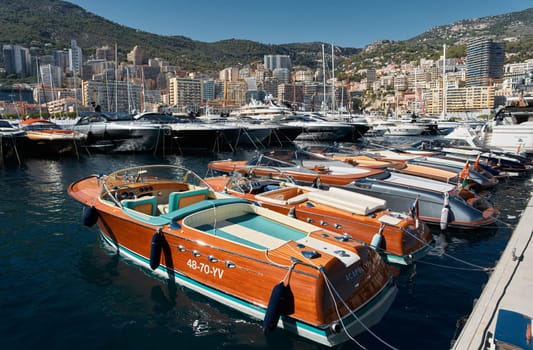 Monaco, Monte Carlo, 28 September 2022 - Riva boats in a row and a lot of luxury mega yachts at the famous motorboat exhibition in the principality, yacht brokers and clients. High quality photo