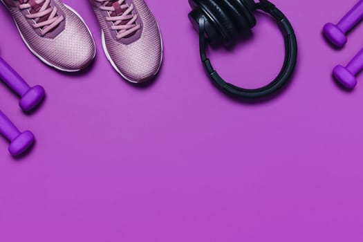 Sports equipment for training at home. Purple background, diagonal composition.