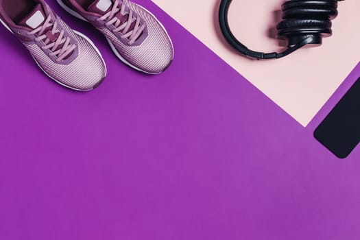 Sports equipment and shoes for women's training. Pink-purple background, diagonal composition.