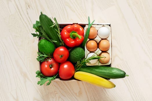 Fresh vegetables in a cardboard box. Fast delivery right from the store.