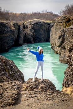 Woman posing in Bruarhlod canyon in Iceland