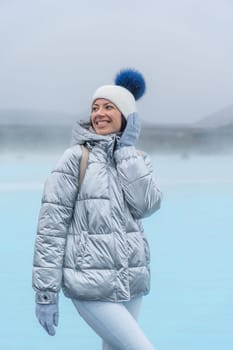 Woman posing with metallic jacket in Blue Lagoon, Iceland