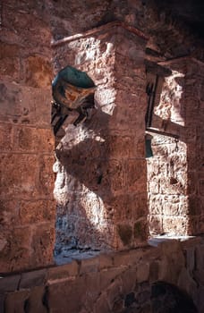 Religious architecture, ancient church bells photo. Sant Miquel del Fai is Benedictine monastery. Monastery passway set in cliffs, Catalonia. High quality picture for wallpaper, article