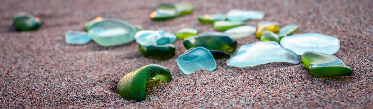 Mediterranean sea beach and glass stones photo. Glass stones from broken bottles polished by the sea. Front view photography with blurred background. High quality picture for wallpaper, travel blog