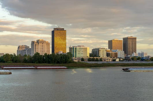 Sunset over the river barges and boats in Mississippi river to skyline of Baton Rouge, the state capital of Louisiana