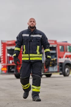 A symbolically brave firefighter strides forward with unwavering courage, epitomizing dedication and leadership, while behind him, a modern firetruck stands ready for firefighting actions, capturing the essence of heroism and preparedness in the face of emergency.