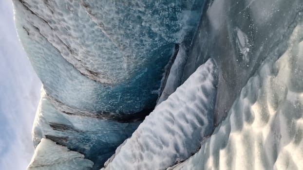 Vatnajokull glacier ice mass in nordic region, spectacular ice rocks with large caves around snowy mountain chain. Majestic frozen icebergs fragments floating on lake, scenic route.
