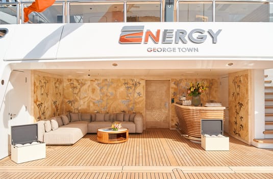 Monaco, Monte Carlo, 29 September 2022 - Close-up view of a relaxation area on the open teak deck of an expensive mega yacht on famous boating exhibition at sunny day, yacht show, wealth life. High quality photo