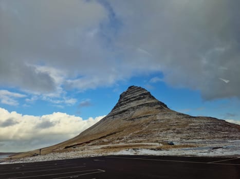 Frozen lands and snowy mountain slopes covered in snow near nordic region countryside, icelandic hills and farmlands in iceland. Scandinavian nature presenting wintry fields and snowy edges.